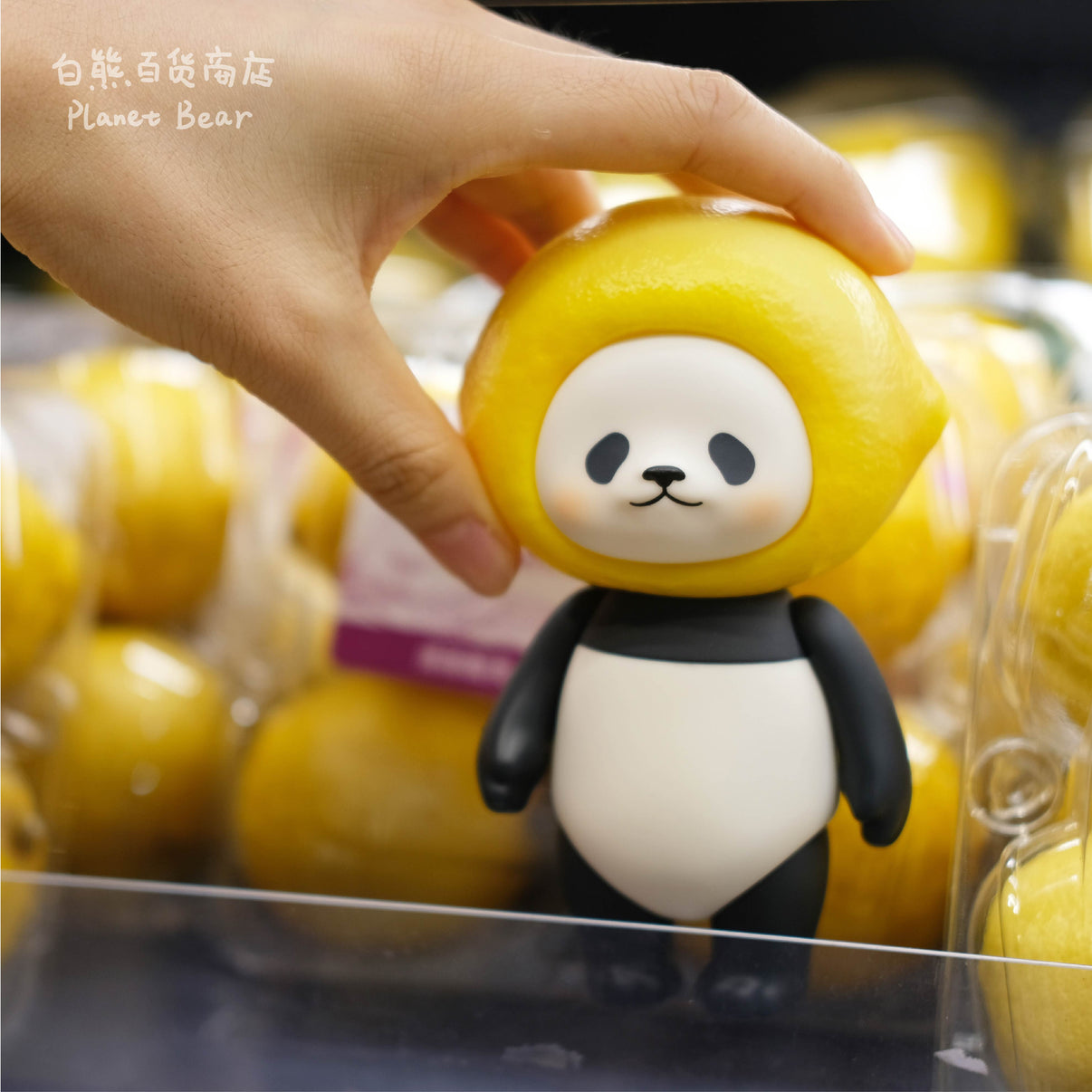 Lemon PanPan collectible figure shown in hand in a fresh lemon display scene