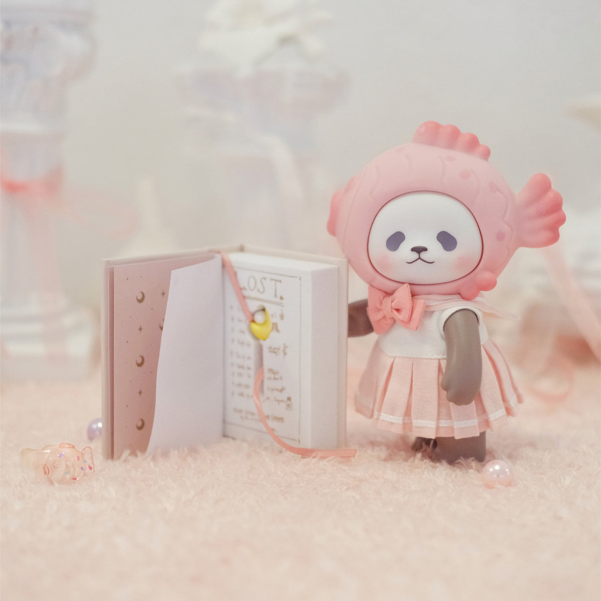 Luna Taiyaki Panda designer figure displayed with a small gift box in a soft pastel scene